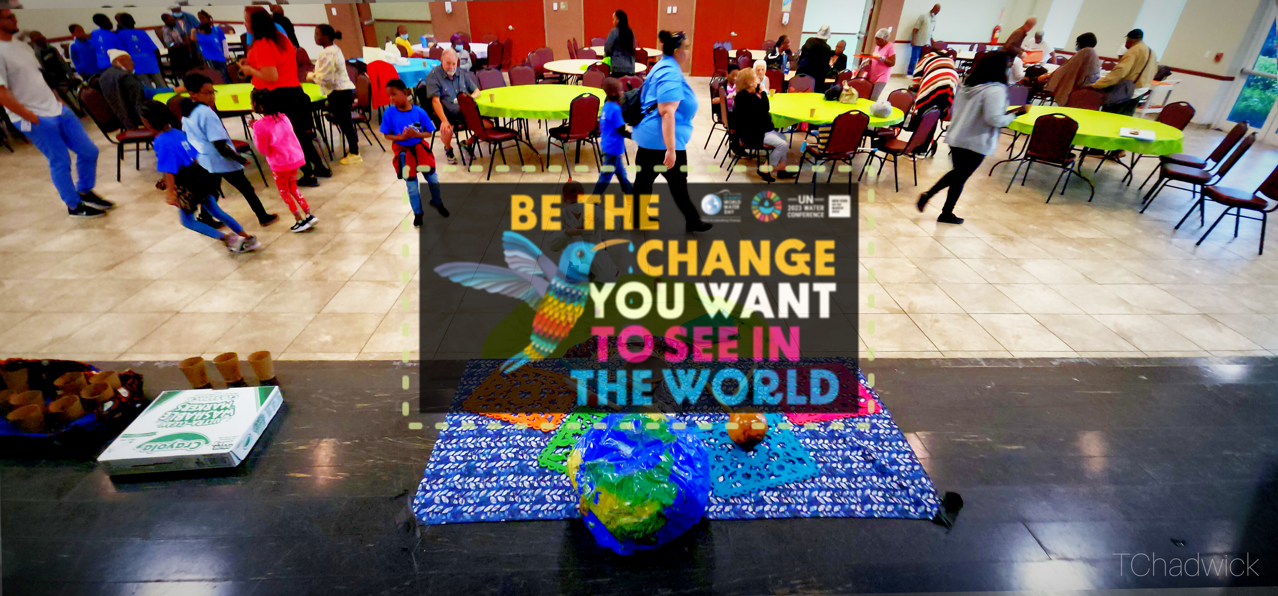World Water Day Graphic from UN 2023 Campaign showing brightly colored stylized hummingbird with BE THE CHANGE text surrounded by children and elders attending an interactive Papalotl Project presentation involving water, soil and seeds with Tara Chadwick at Miramar Multiservice Complex Community Center