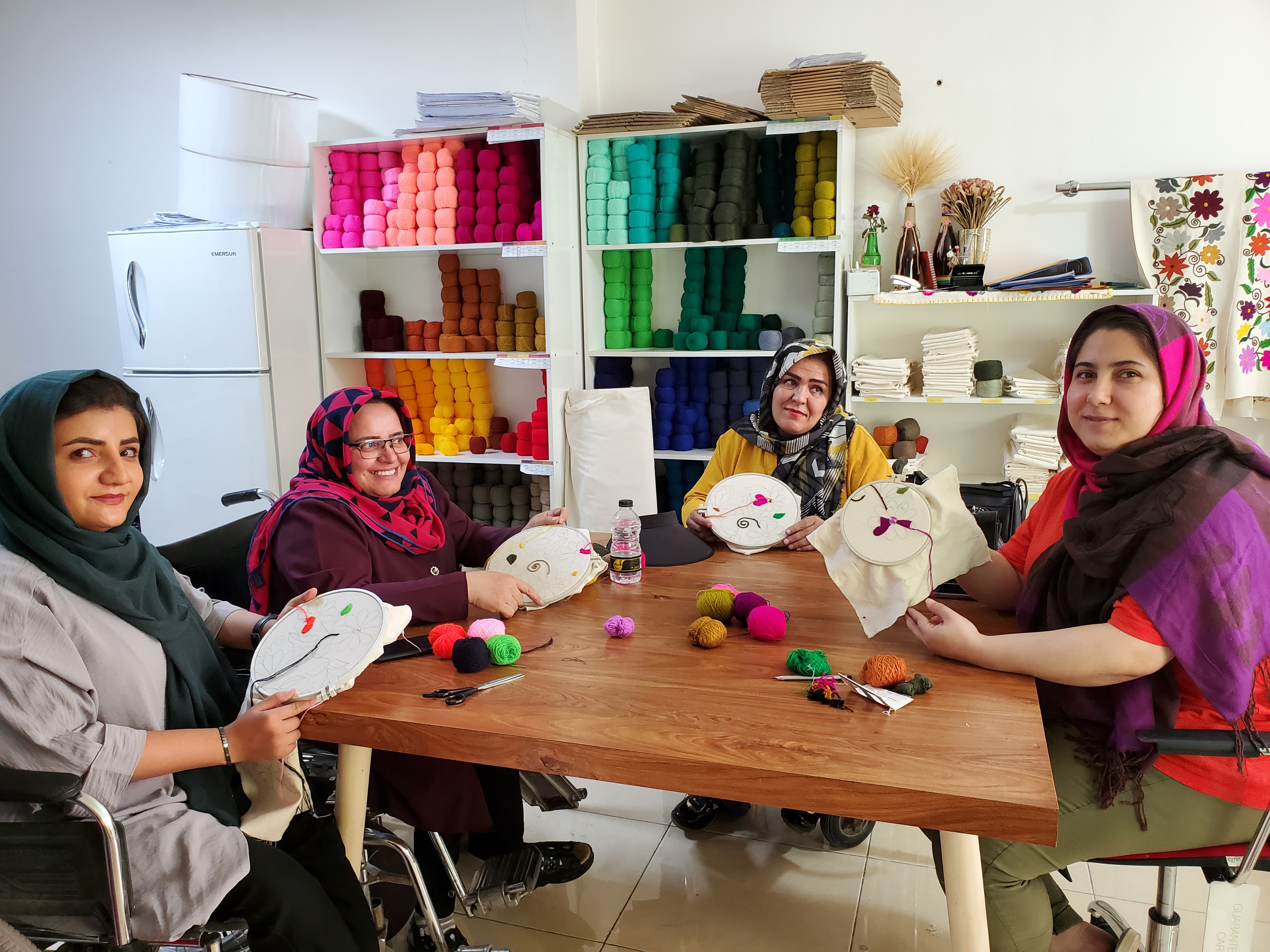 Fatemeh and 3 disabled women in a hand embroidery workshop 