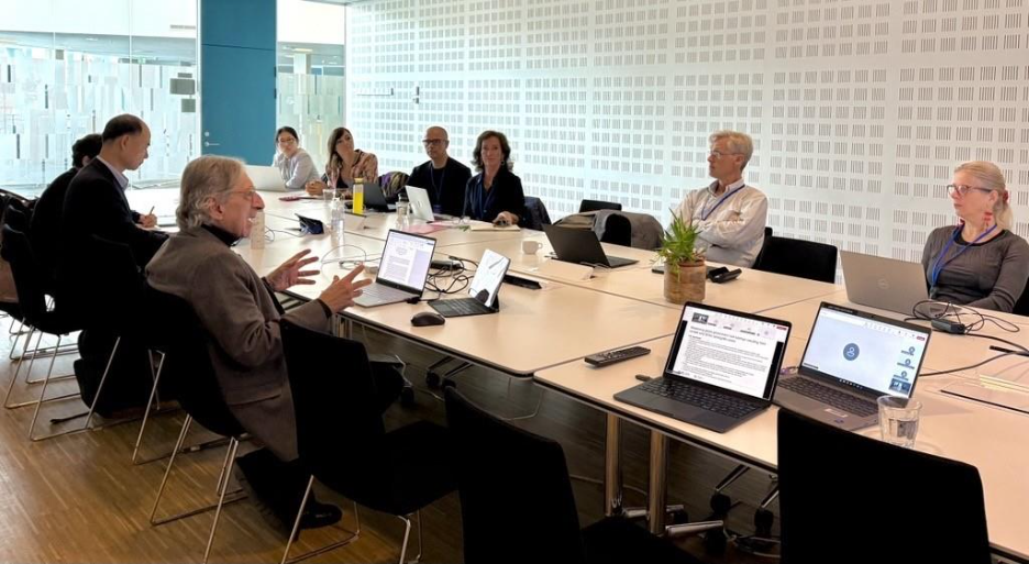 A group of people sitting around a table
AI-generated content may be incorrect.